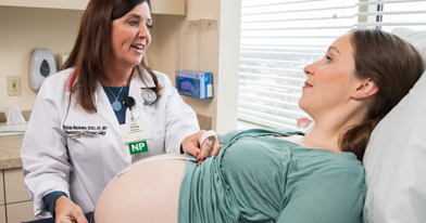 Nurse Practitioner examining pregnant patient